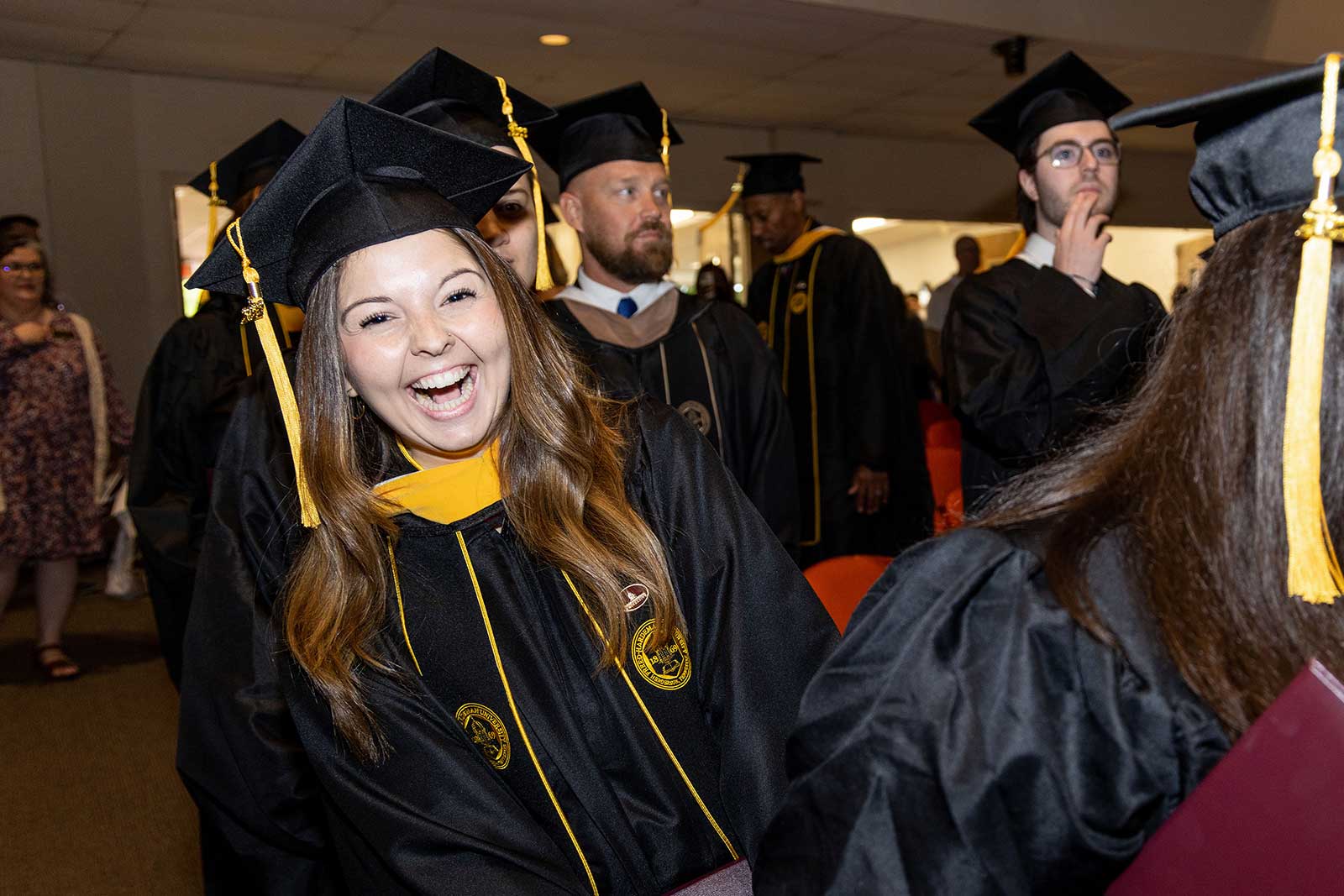 students smiling at commencement