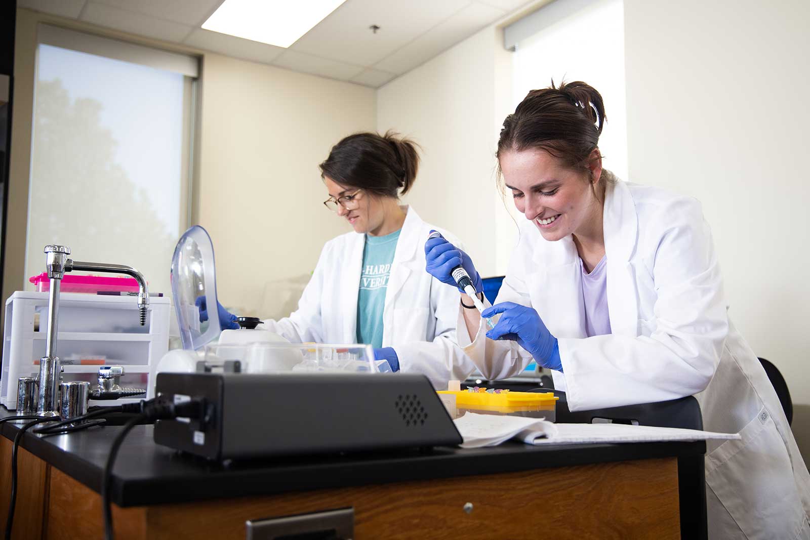 Two female students conducting research in a science lab