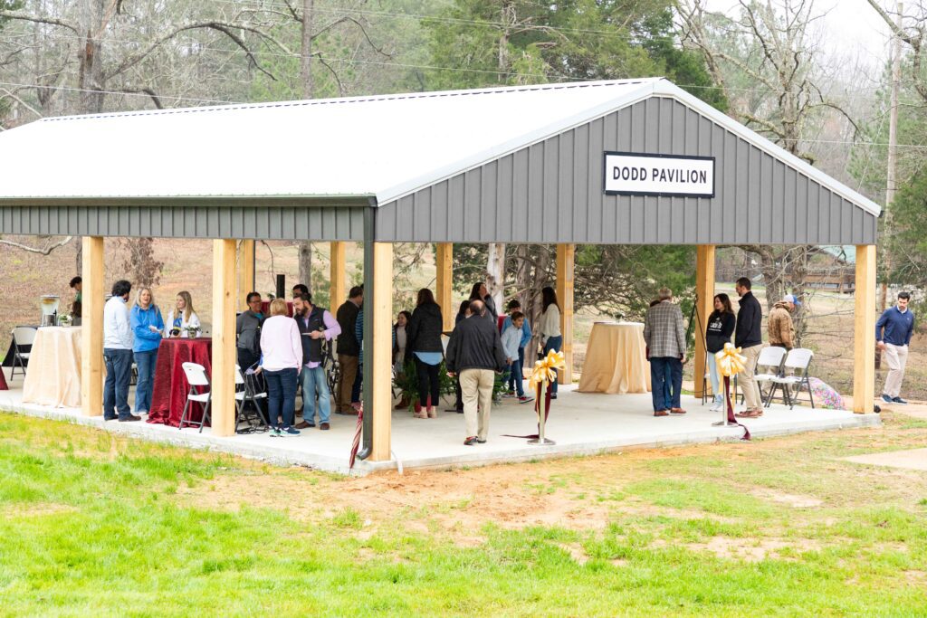 Members of the Dodd family, along with representatives from FHU and MSYC, gathered to celebrate the new camp pavilion March 9, 2024.
