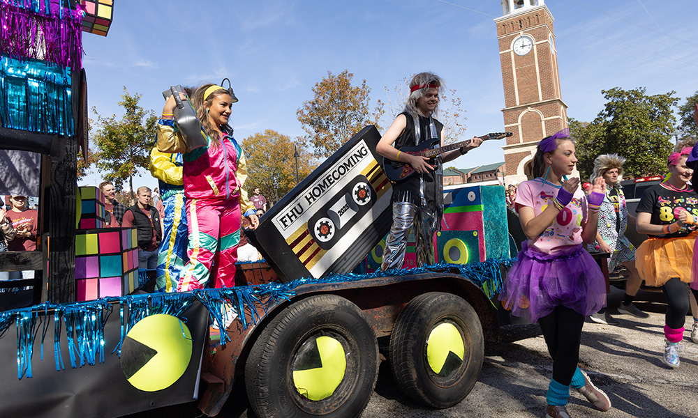 Members of Sigma Rho showcase their 1980's themed float entitled "Back in Black."