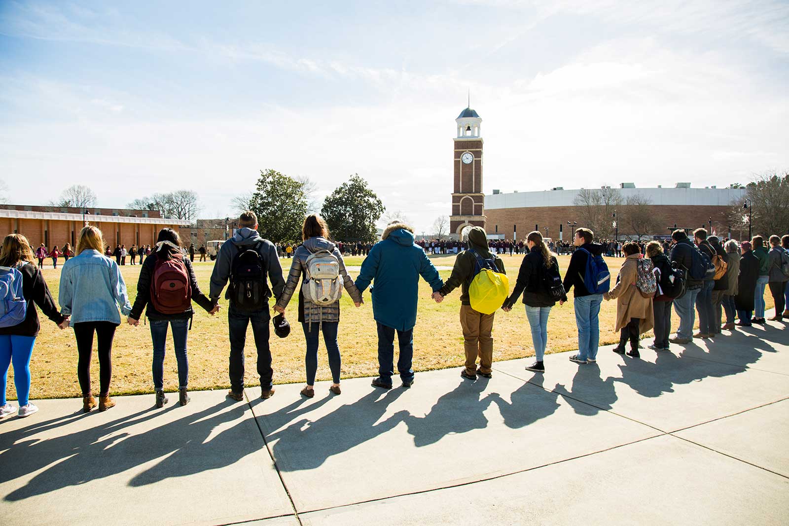 new - large student prayer around clock tower at during day
