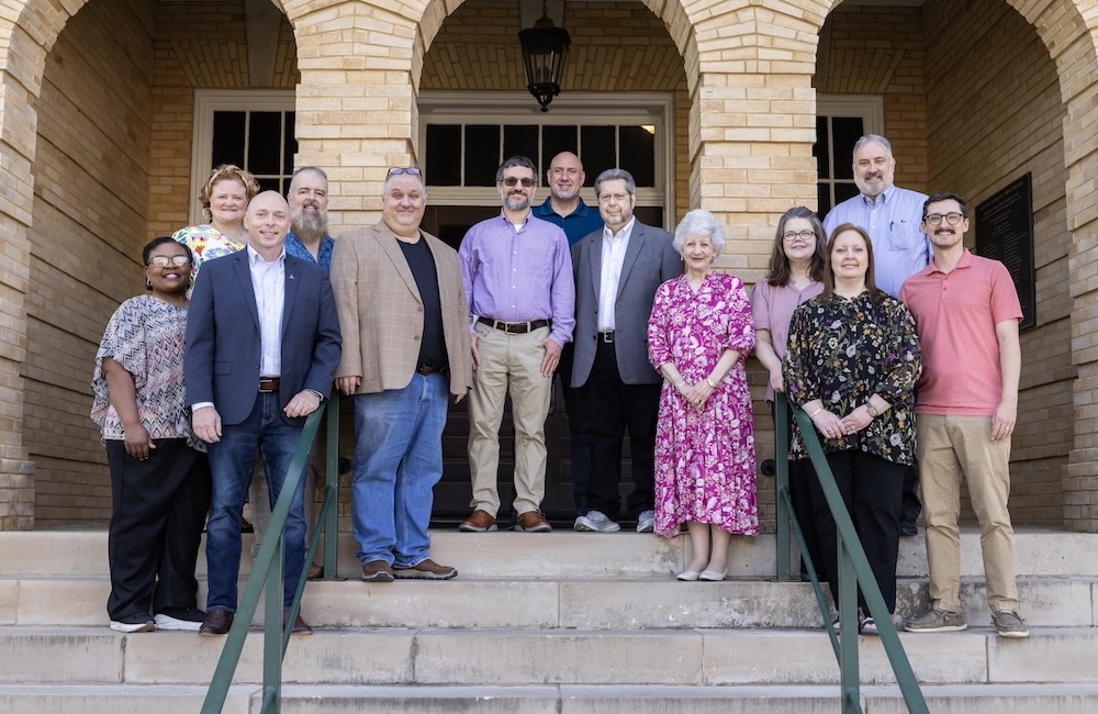 The FHU Behavioral Sciences department stand on the steps of Old Main