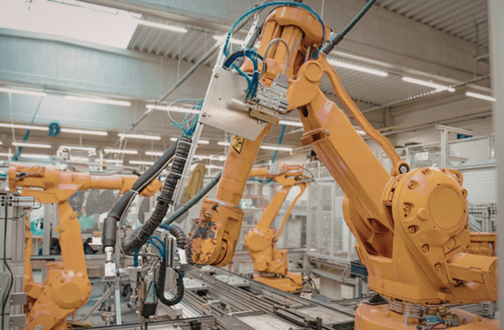 Robot construction arms working inside of a factory