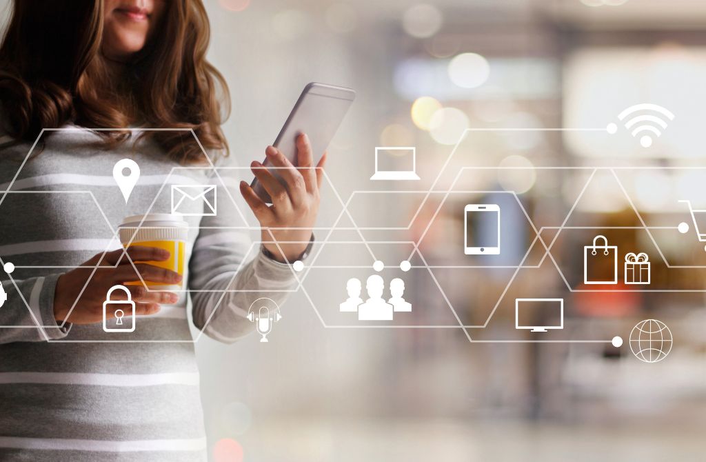 a person looking at a phone, with app icons scattered across the picture