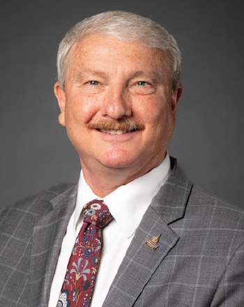David Shannon, chancellor, smiling with a FHU pin on his tuxedo
