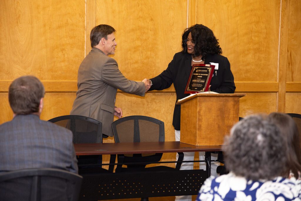 Dr. Sharen Cypress, dean of the FHU College of Education and Behavioral Sciences, presents Chester County Director of Schools Troy Kilzer II with an award during the luncheon.
