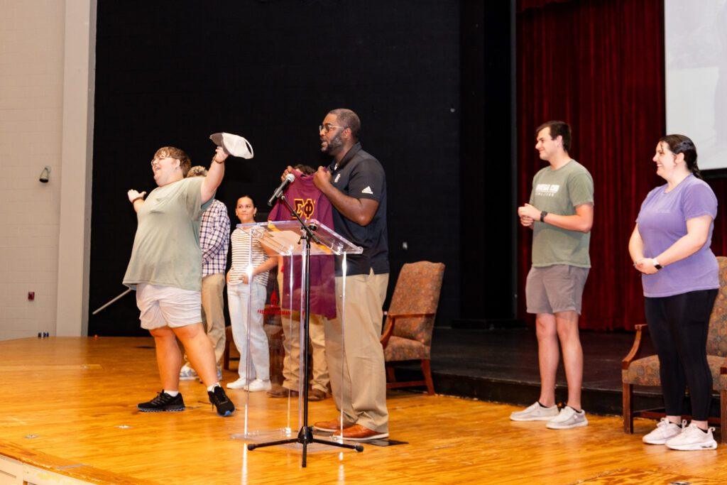 TJ Kirk presents Nolan Gupton with a special jersey naming him an honorary member of all five social clubs on campus.