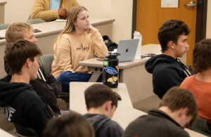 A group of students listening attentively to the speaker