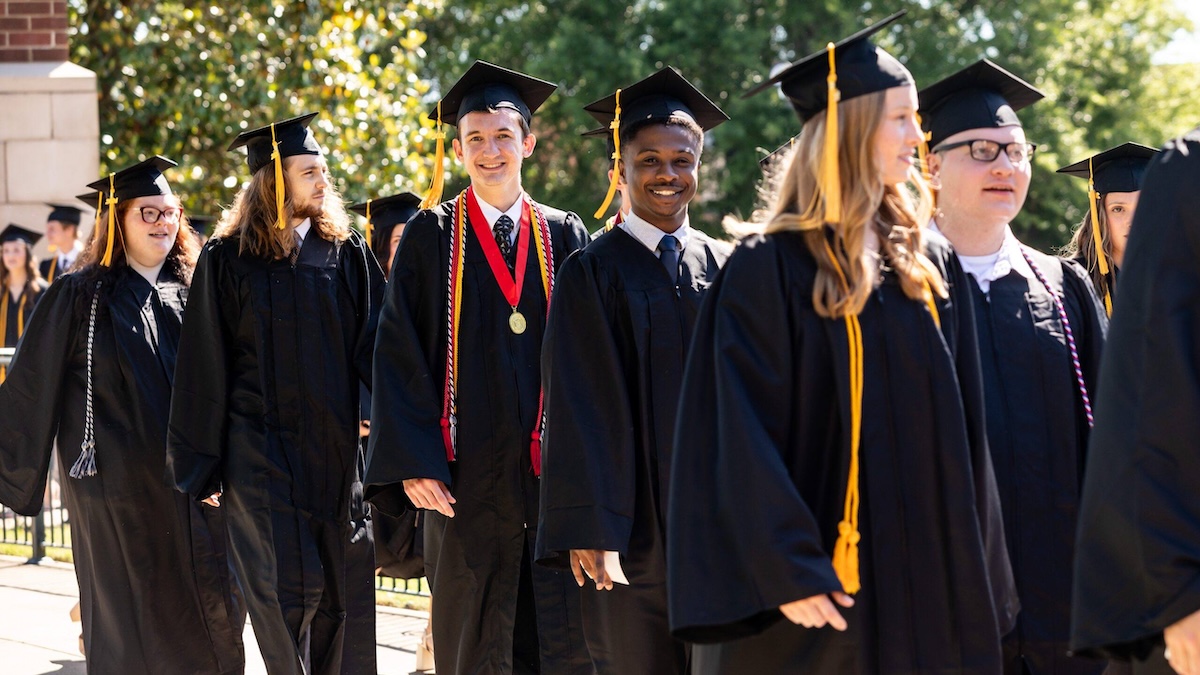 graduates smiling while in a line