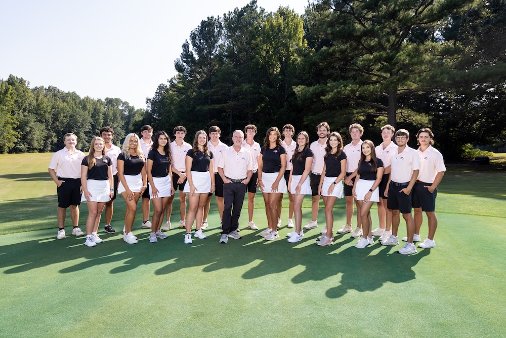 photo of the Freed Hardeman Golf team. All are smiling, standing on a golf course, in their Freed-Hardeman uniforns.
