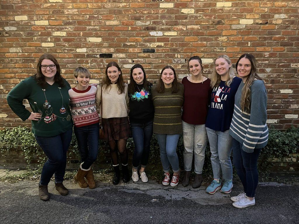 The group celebrates performing one of their first outdoor concerts during an event at Besso's, Christmas 2021.