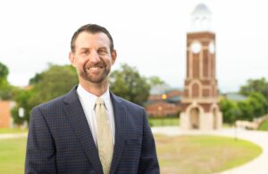 Ryan Malecha posing in front of belltower