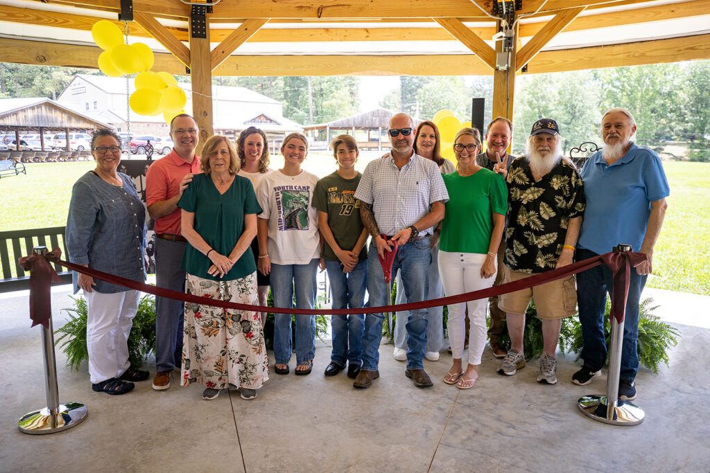Mykal's friends and family, along with representatives from MSYC, cut the ribbon to officially open Mykal's Sonshine Circle.