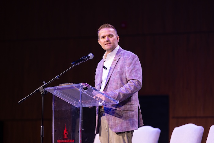 President Keith Harris speaking on stage in Dryden Auditorium