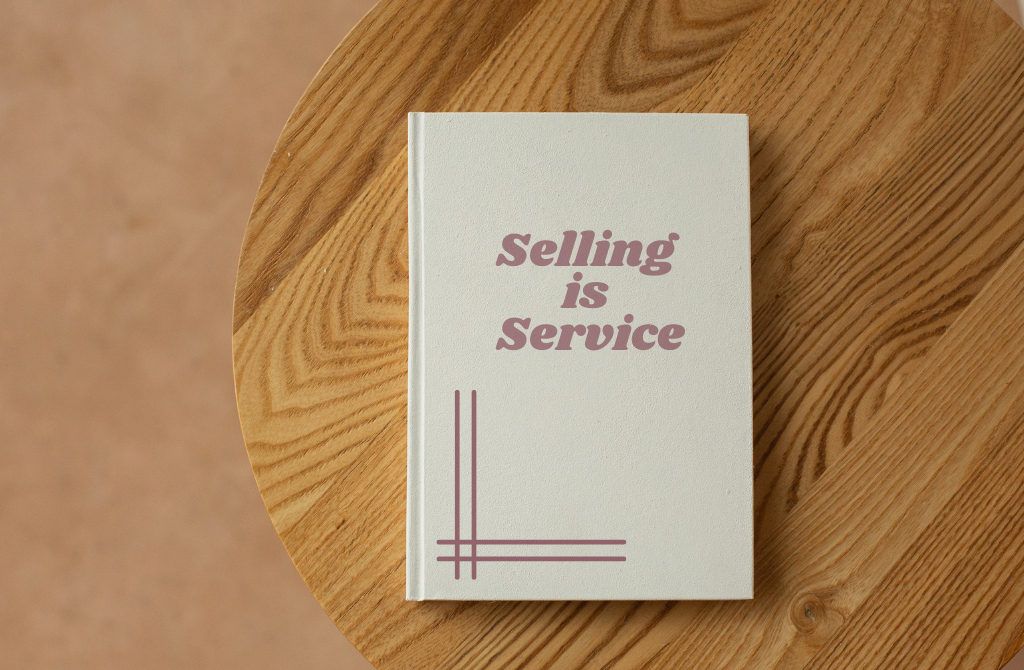 Selling is Service - a book on top of a wooden table