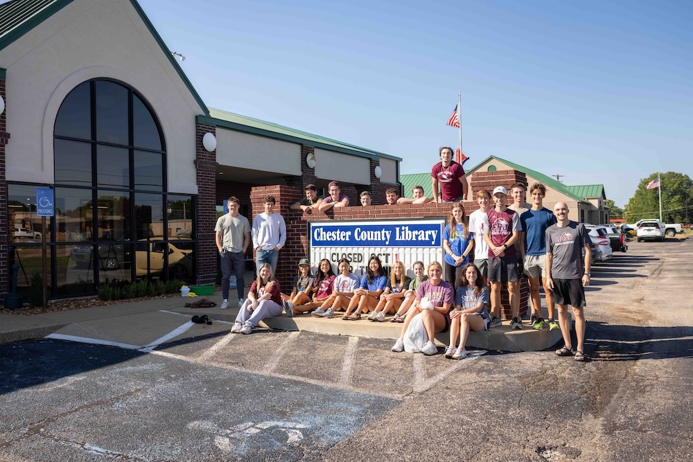 Members of the FHU cross country and track and field teams help complete tasks in and around the Chester County Library.