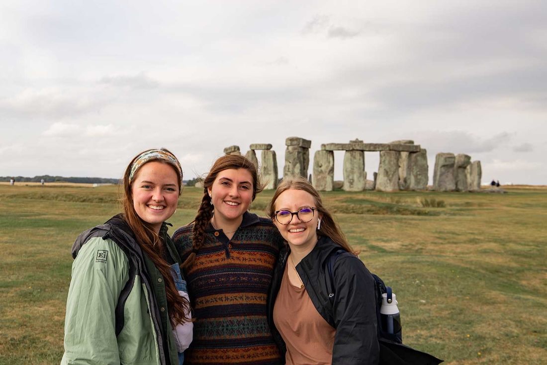 A group of students pose for a picture at Stonehenge while on a study abroad trip
