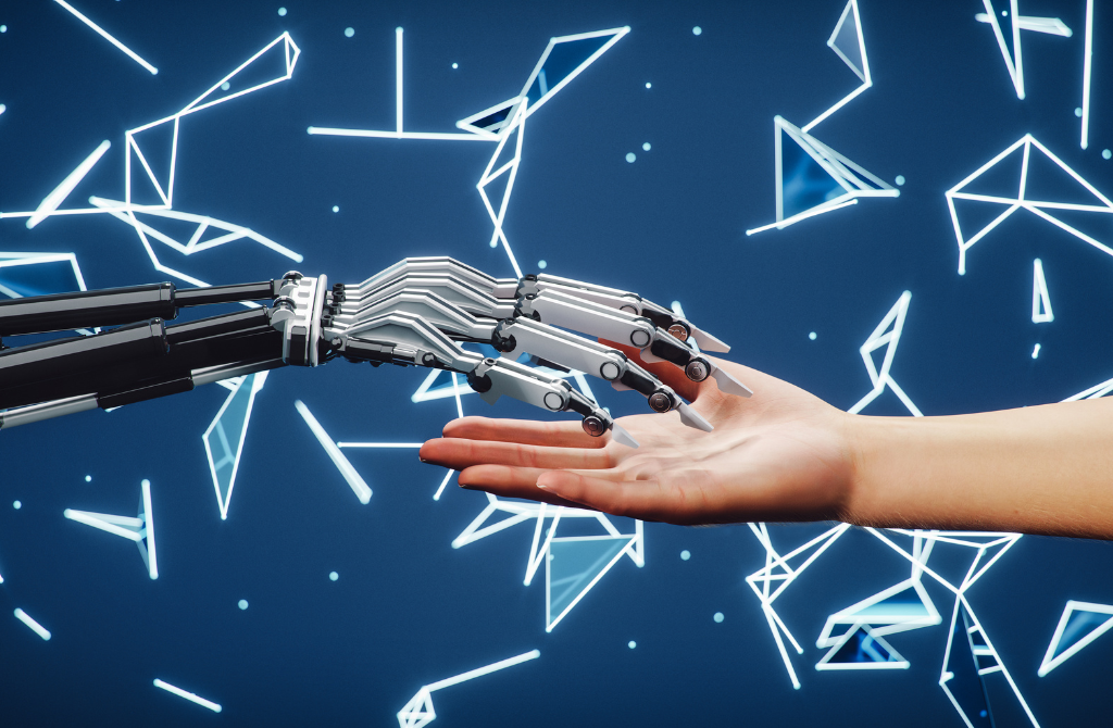 a human hand reaching out to shake a robotic hand constructed of metal